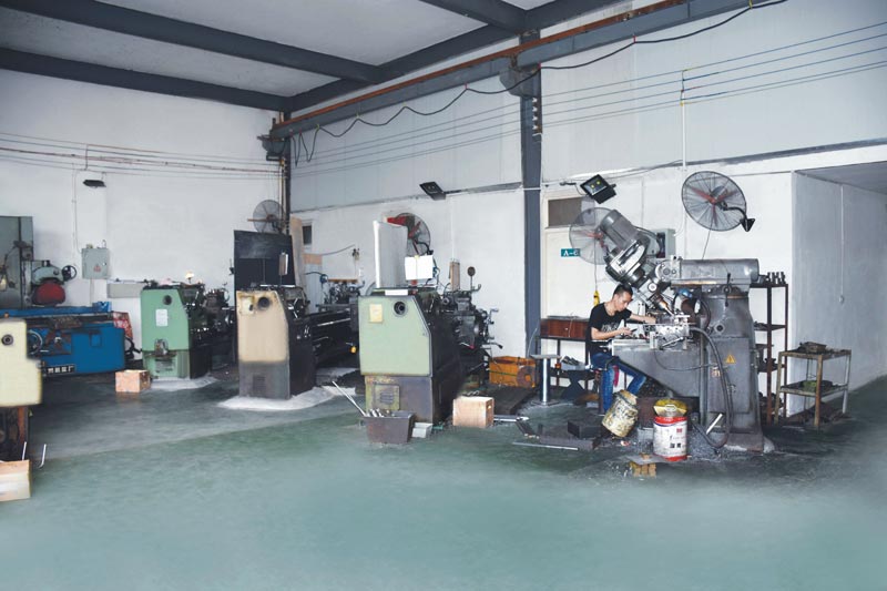 Actual Scene from the Factory Workshop: Workers Operating Machine Tools for Precision Machining of Components